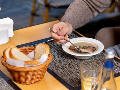 Glass of water on a minimalist table next to a mat.